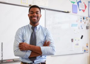 Portrait of confident African American male teacher in class