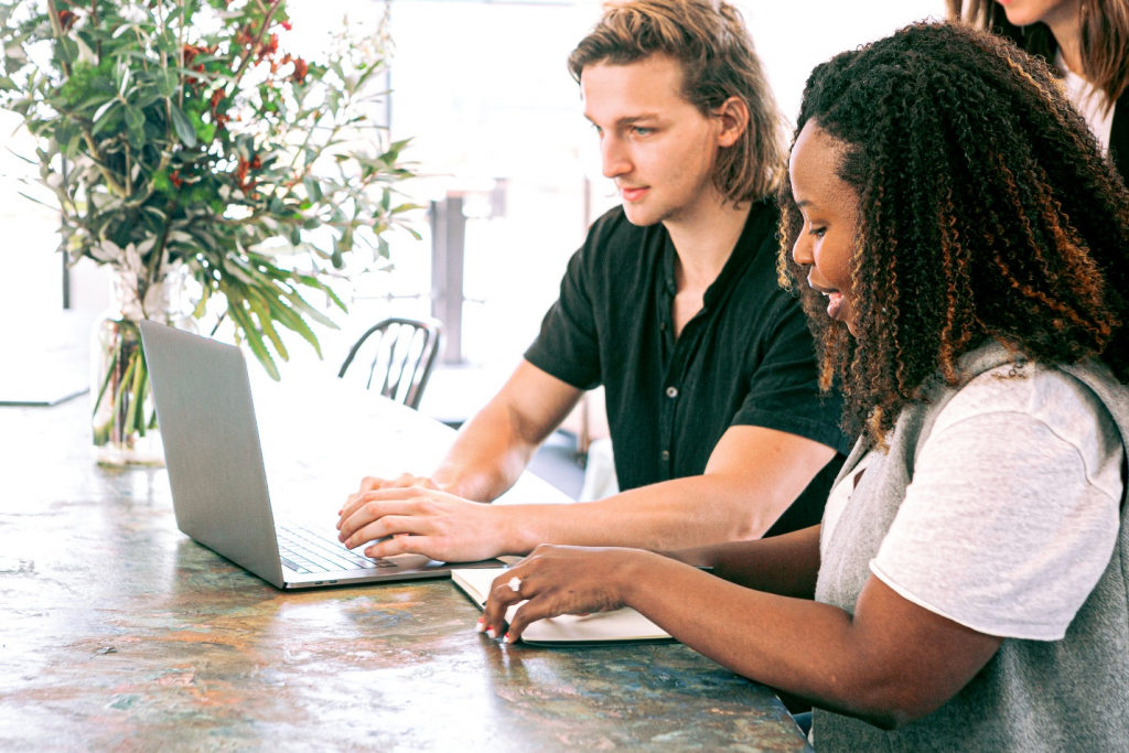 Two coworkers working on a laptop